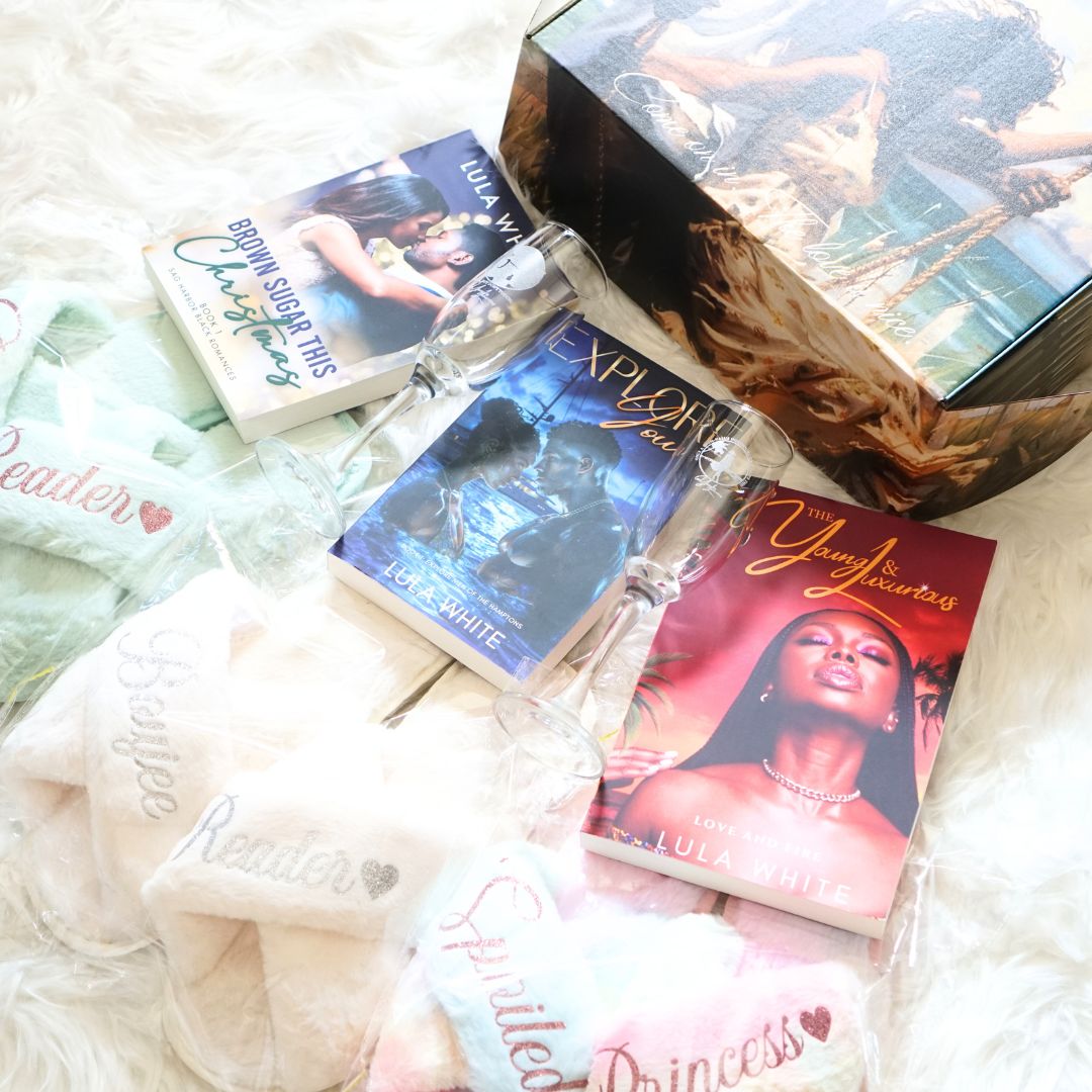 three romance novels, two champagne flutes, three pairs of furry house slippers, and a decorative shipping book box