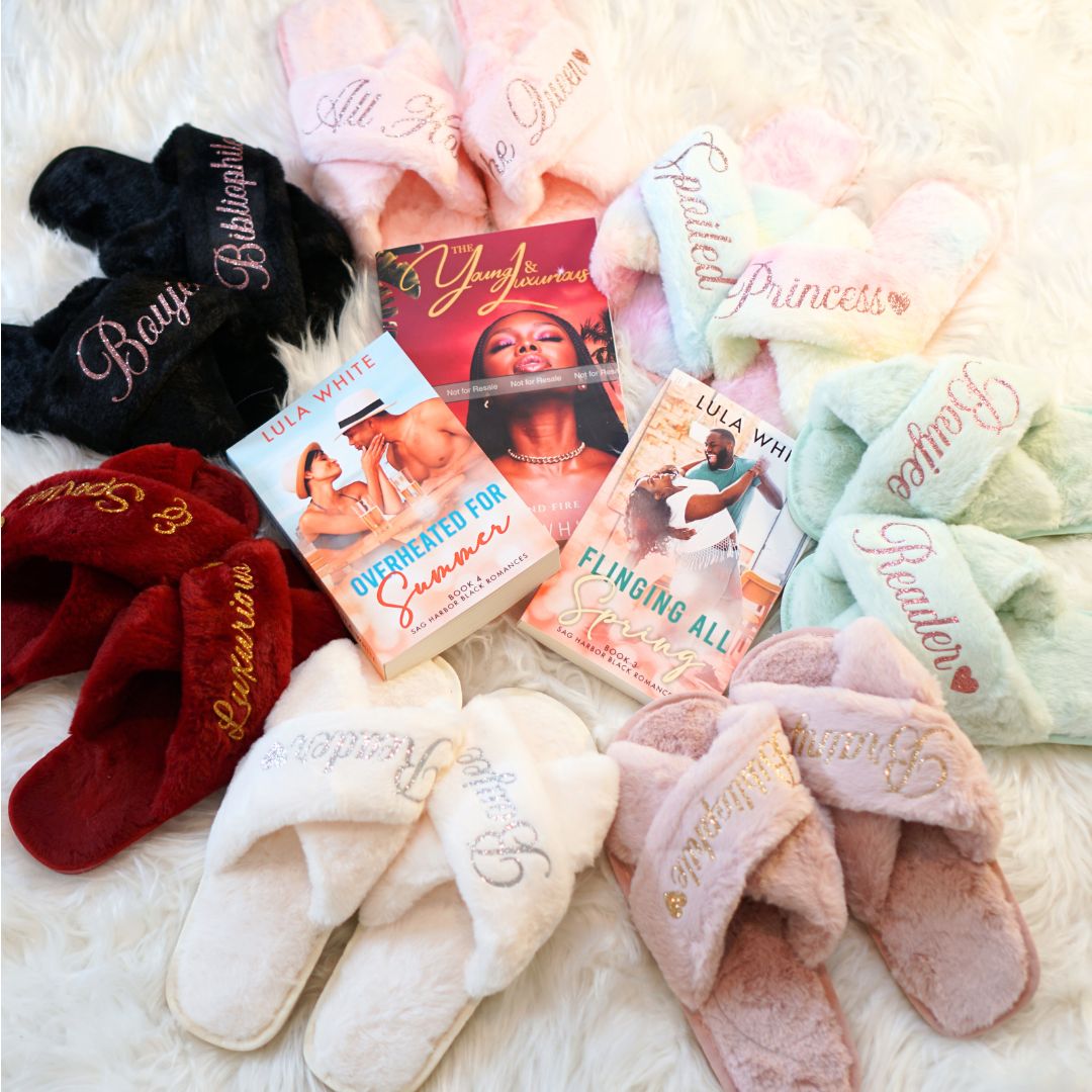 several pairs of house slippers in varying colors surrounding three paperback books